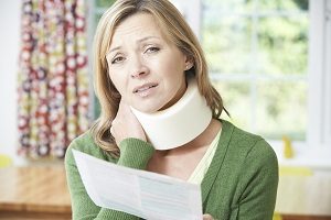 Woman Reading Letter After Receiving Neck Injury