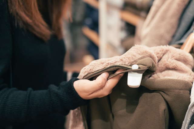 woman holding a jacket in a store